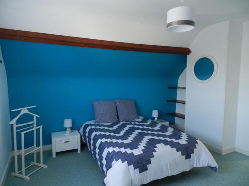 滨海圣洛朗La Maison Blanche的蓝色的卧室,配有床和蓝色的墙壁