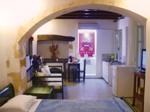 干尼亚麦当娜一室公寓酒店的厨房以及带拱门的起居室。