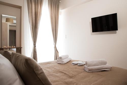 雅典AT.thea ATHENS BOUTIQUE APARTMENTS的一间卧室配有带毛巾的床