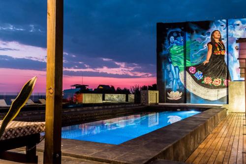 埃斯孔迪多港Cabane Container Hotel - ADULTS ONLY的一座画作建筑屋顶上的游泳池