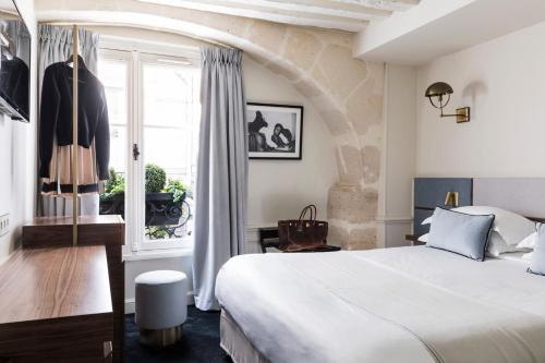 巴黎沃穆尔圣日耳曼酒店的一间卧室设有一张大床和一个窗户。
