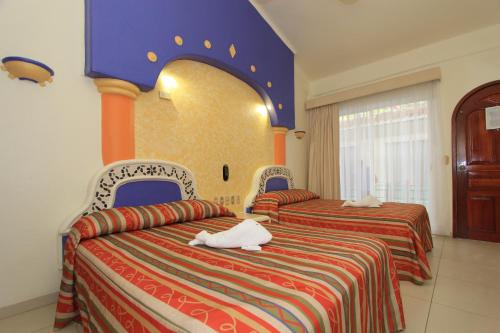 圣克鲁斯华特库埃克斯泰尔酒店的酒店客房,设有两张红色和蓝色的床