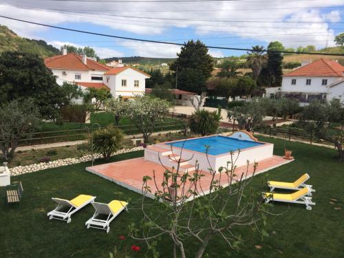 阿伦克尔Quinta Ribeira do Labrador - Lisbon West Wine Route的一个带游泳池和一组椅子的庭院
