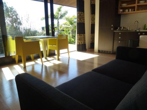 热水海滩Hot Water Beach Bure Wai的客厅配有沙发和桌椅