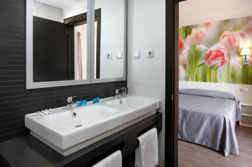 马尔格莱特德玛Hotel Amaraigua – All Inclusive – Adults Only的一间带白色水槽和床的浴室