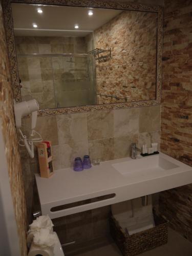 卡尔佩Hotel Maravillas del Mundo的一间带水槽和镜子的浴室