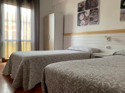 TrapagaranMontero Sestao Bilbao的酒店客房设有两张床和窗户。