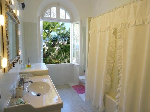 罗德镇Romantic rooms with stunning sea view的白色的浴室设有水槽和窗户。
