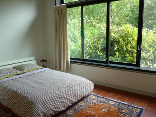 Contra卡萨奥林度假屋的一间卧室设有一张床和一个大窗户