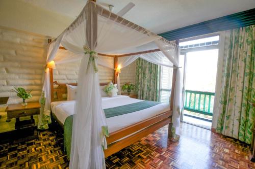 TsavoTaita Hills Safari Resort & Spa的一间卧室设有一张天蓬床和一个阳台