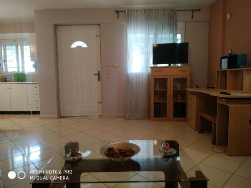阿特米达Stavros Apartments的客厅配有桌子、电视和门