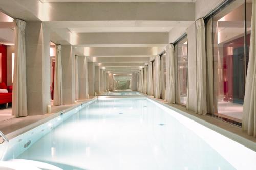 巴黎La Réserve Paris Hotel & Spa的建筑物走廊上的游泳池