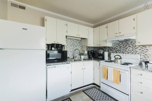 岩石丘Cute Condo in Rock Hill-45的厨房配有白色橱柜和白色家电