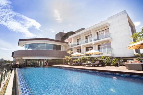 万隆格兰蒂亚酒店的建筑前的一座带游泳池的建筑