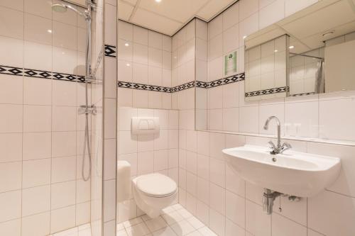 阿姆斯特丹阿姆斯特丹新西酒店的白色的浴室设有水槽和卫生间。