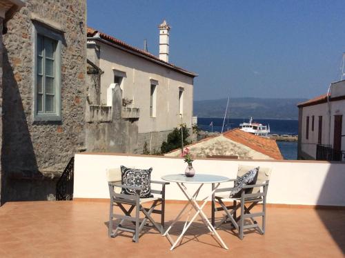 伊兹拉Astraea的阳台配有桌椅和灯塔
