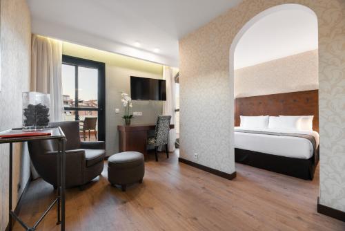 卡塞雷斯卡塞雷斯伊科斯阿戈拉酒店的配有一张床和一张书桌的酒店客房