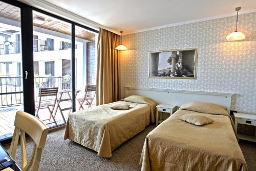 瑞吉娜玛丽亚温泉设计酒店客房内的一张或多张床位