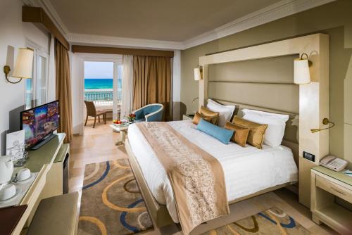 苏塞Sousse Palace Hotel & Spa的酒店客房设有一张大床和一台电视。