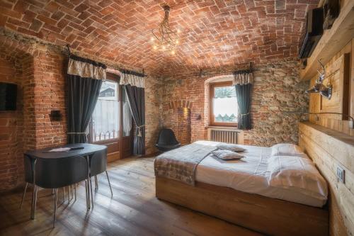 韦尔南泰纳吉恩纳尔酒店的一间卧室设有一张床和砖墙