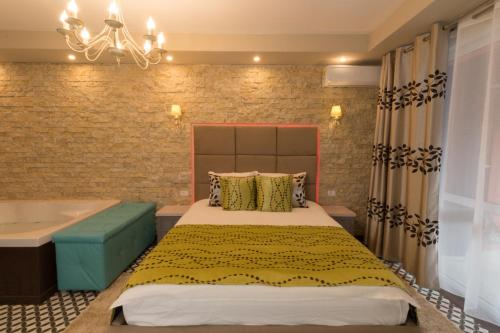 锡纳亚Romantic Jacuzzi Belleview Studio的一间卧室配有一张床和浴缸