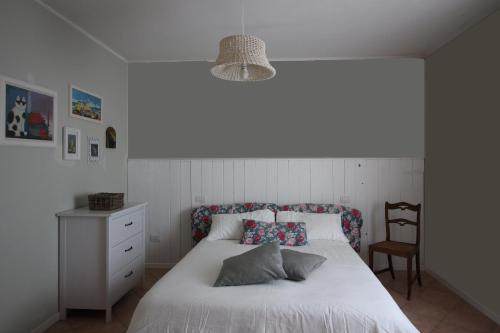里米尼Casa S.Paolo的卧室配有白色的床和椅子