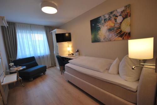赖因伯伦斗兽场旅馆的配有一张床和一张书桌的酒店客房