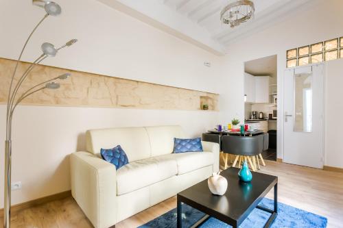 巴黎Marais Saint Paul Ecouffes的客厅配有白色的沙发和桌子