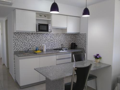 罗萨里奥Pasco 1847 Apartamento 5B的厨房配有白色橱柜和台面