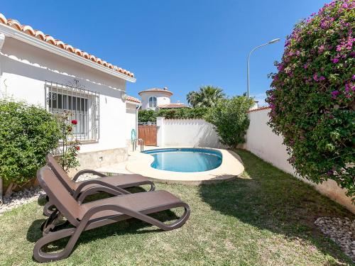 德尼亚Holiday Home Tossal Gros by Interhome的一个带椅子的庭院和一个游泳池