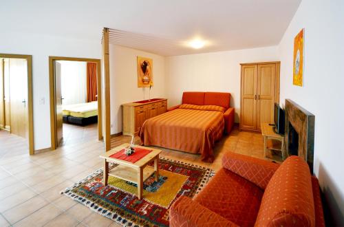 圣贝纳迪诺圣贝纳迪诺公寓式酒店的客厅配有床和沙发