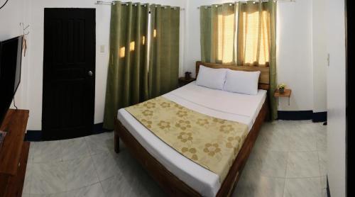公主港Keen's Place的一间卧室配有一张带绿色窗帘的大床