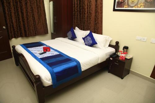 钦奈Jai Palace的床上有蓝色和白色的毯子