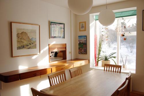 雷克雅未克Úlfarsfellsvegur 20, 113 Rvk Birkihlid的一间带木桌和窗户的用餐室