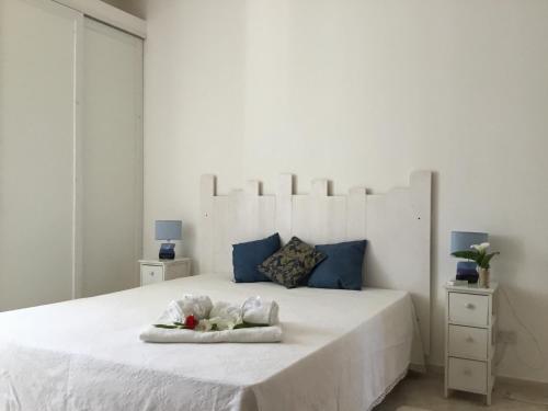托雷圣乔万尼乌B&b Masseria Nova的白色卧室配有一张蓝色色调的大型白色床
