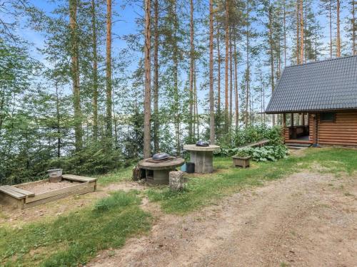 VuoriniemiHoliday Home Iltarusko by Interhome的小屋设有野餐桌和林地长凳