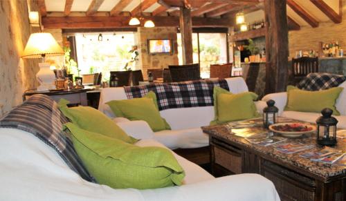 锡古恩萨Hotel Rural el Arrabal Siguenza的客厅配有白色沙发和绿色枕头。