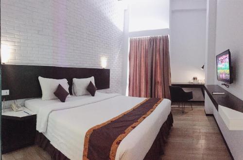 明古鲁艾科斯塔酒店客房内的一张或多张床位
