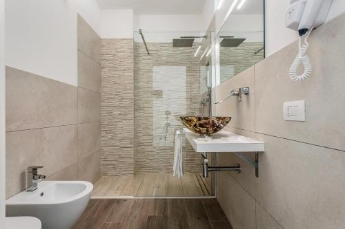 丽都迪萨维奥阿夏戈海滩酒店的一间带水槽和碗在柜台的浴室