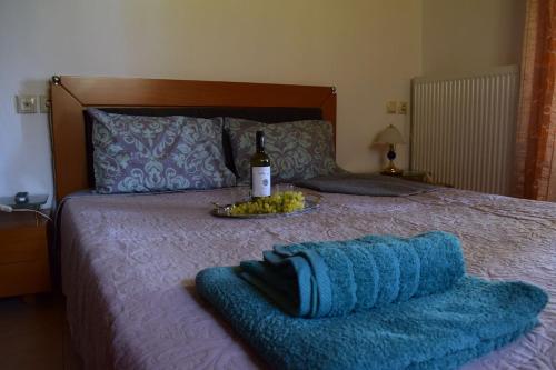 霍里顿Holiday Home Dionysis的一张带一瓶葡萄酒和毯子的床