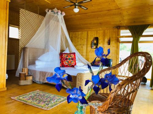 SviniţaDream Tricule的一间卧室,卧室内配有一张蓝色鲜花的床