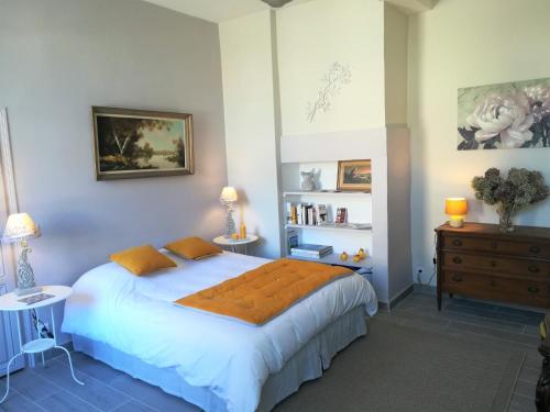 MorlaasLe Clos Sainte Foy的卧室配有带橙色枕头的大型白色床