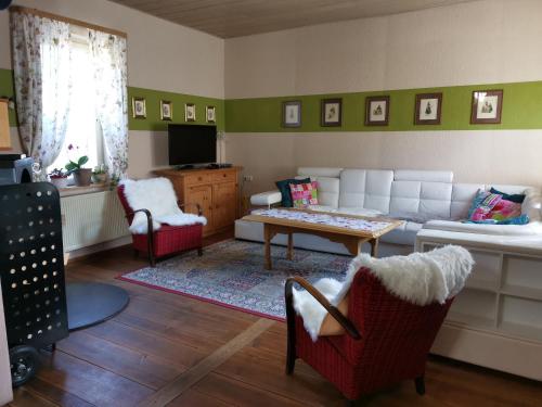 HausenFerienhaus vom Bahratal的客厅配有沙发和桌椅
