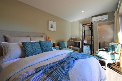 库珀海滩BeachBox Boutique Accommodation的一间卧室配有一张带蓝色枕头的大床