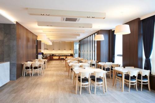 首尔梅非里斯酒店的一间设有白色桌椅的用餐室