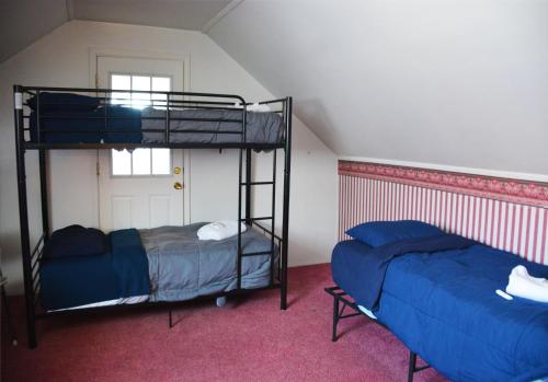 底特律Hamtramck Hostel的客房设有两张双层床和一扇窗户。