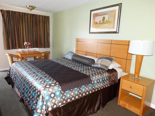 Brookfield科珞倪汽车旅馆的酒店客房设有一张大床和一张桌子。