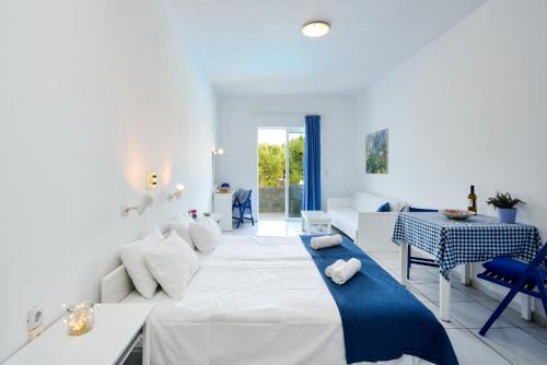 耶奥伊乌波利斯玛丽卡套房公寓式酒店的白色卧室配有一张大床和一张桌子