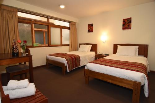 库斯科普利斯玛库斯科酒店的酒店客房设有两张床和窗户。