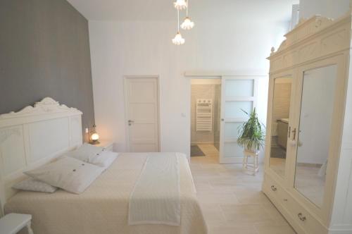 图勒Chambre d'hôtes à TOUL centre ville avec parking privé的白色的卧室配有白色的床和镜子